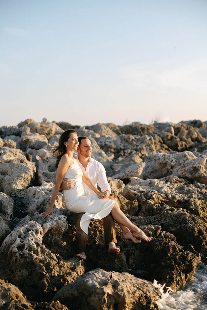 Couple on beach for engagement photos in naples at Via Miromar Beach