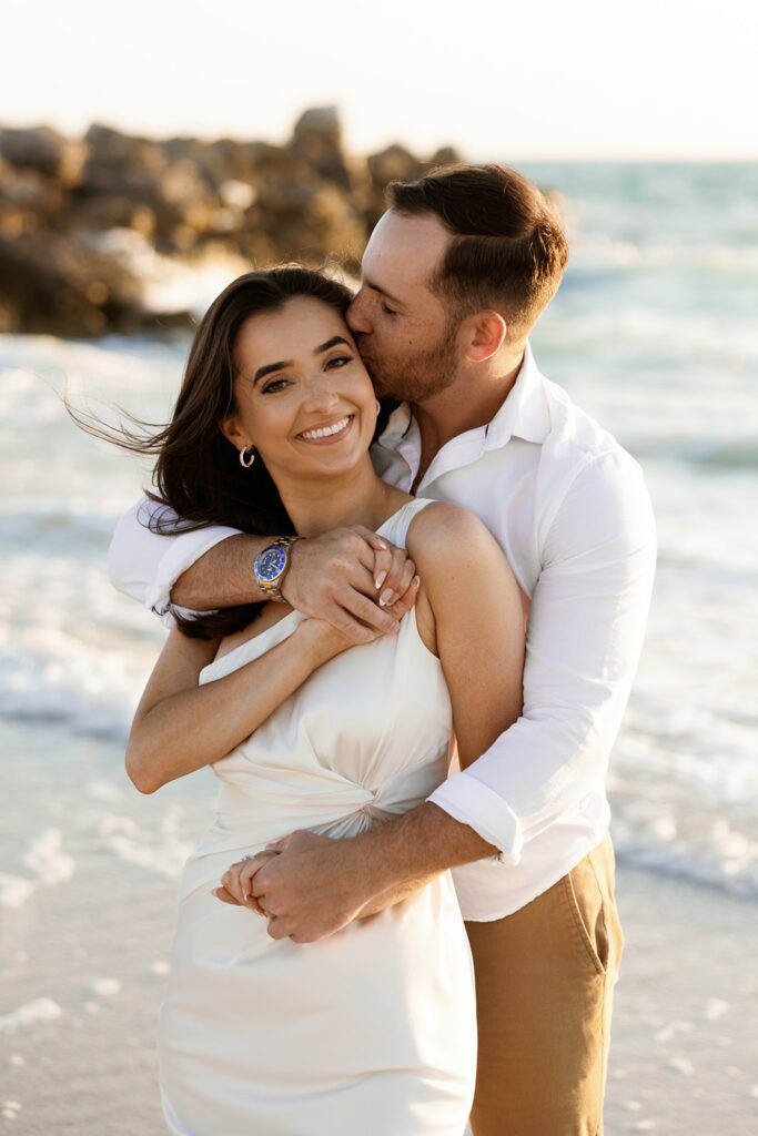 Couple on beach for engagement photos in naples at Via Miromar Beach