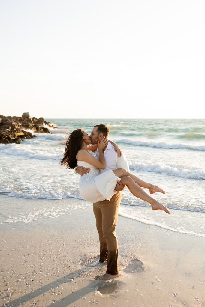 Couple on beach for engagement photos in naples at Via Miromar Beach