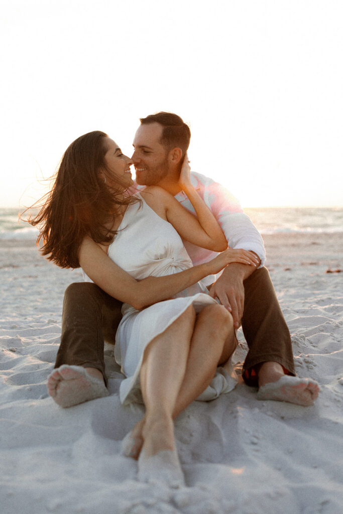 Couple on beach for engagement photos in naples at Via Miromar Beach