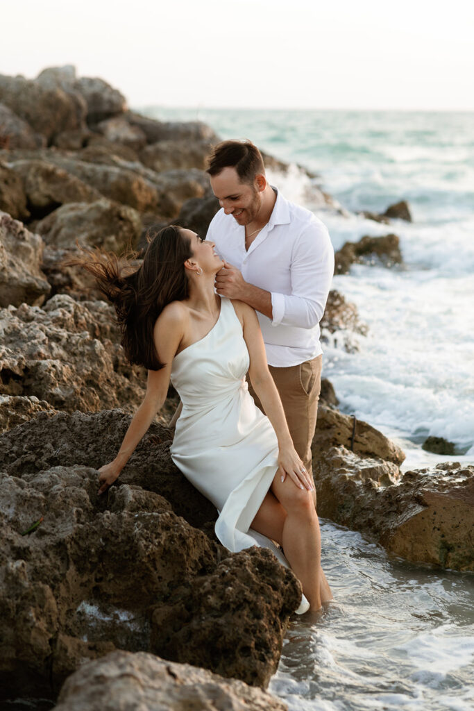 Couple on beach for engagement photos in naples at Via Miromar Beach