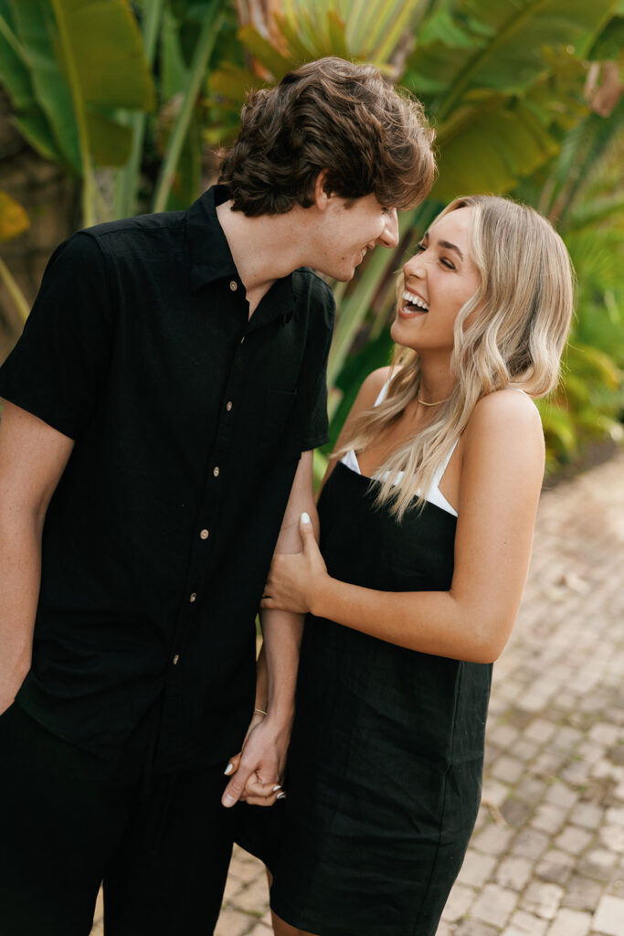couple laughing for their downtown naples beach engagement