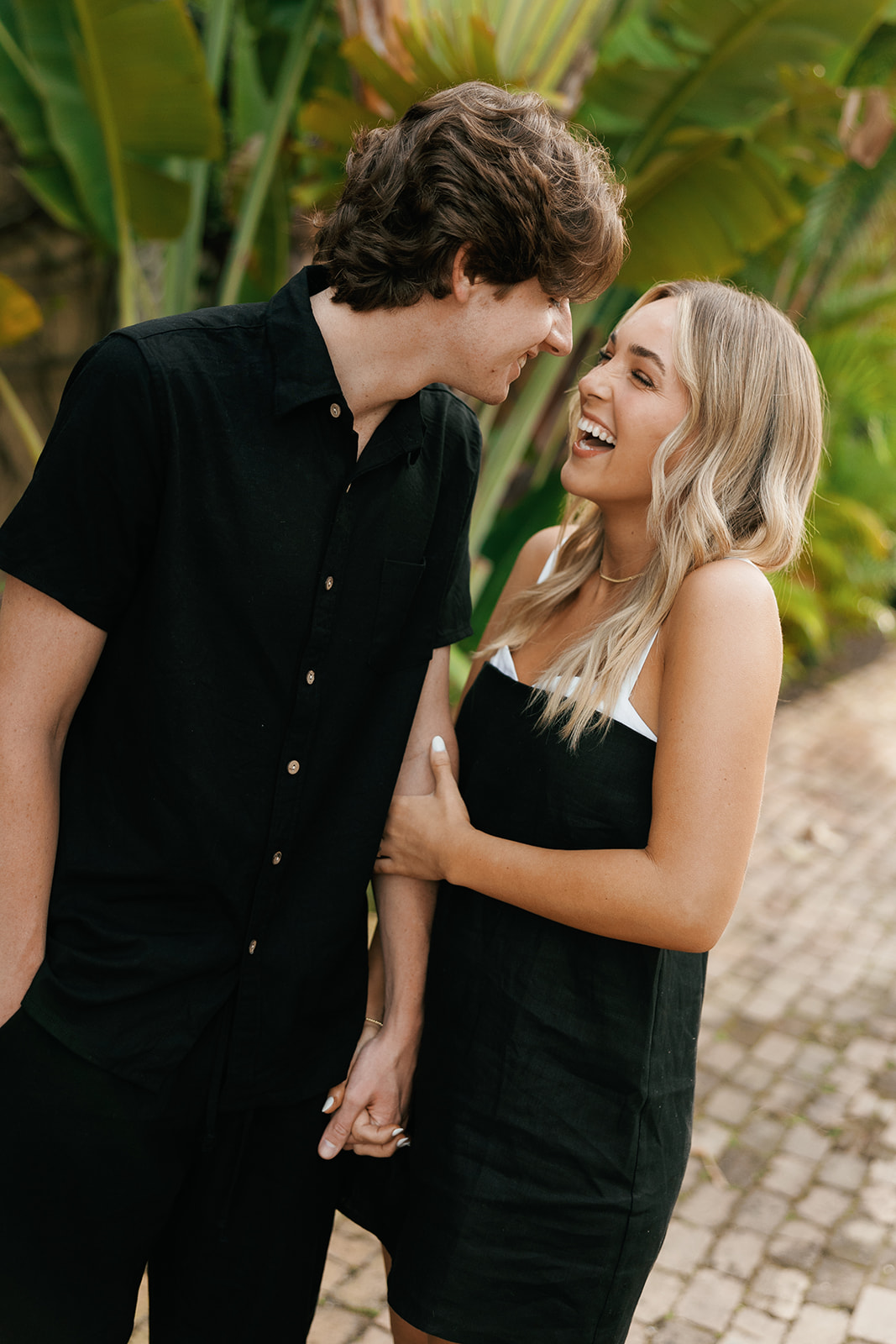 couple laughing for their downtown naples beach engagement