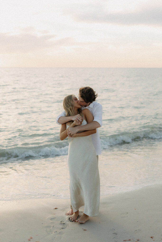 couple kissing on beach in Naples fl downtown