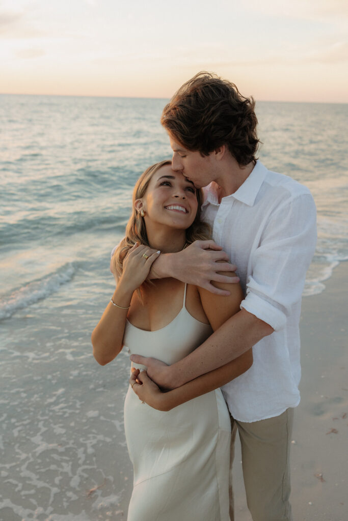 couple looking at each other for naples florida beach sunset engagement photos