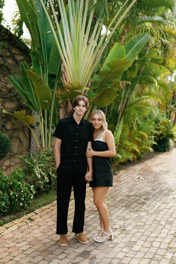couple embracing for downtown naples beach engagement session