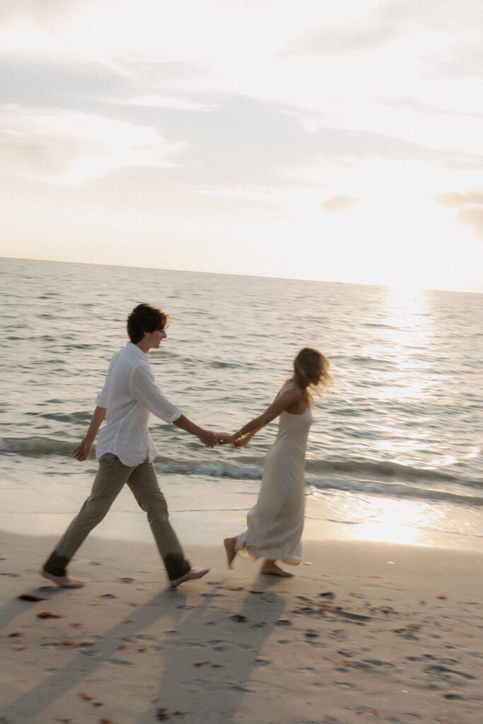couple walking laong naples florida beach sunset photo