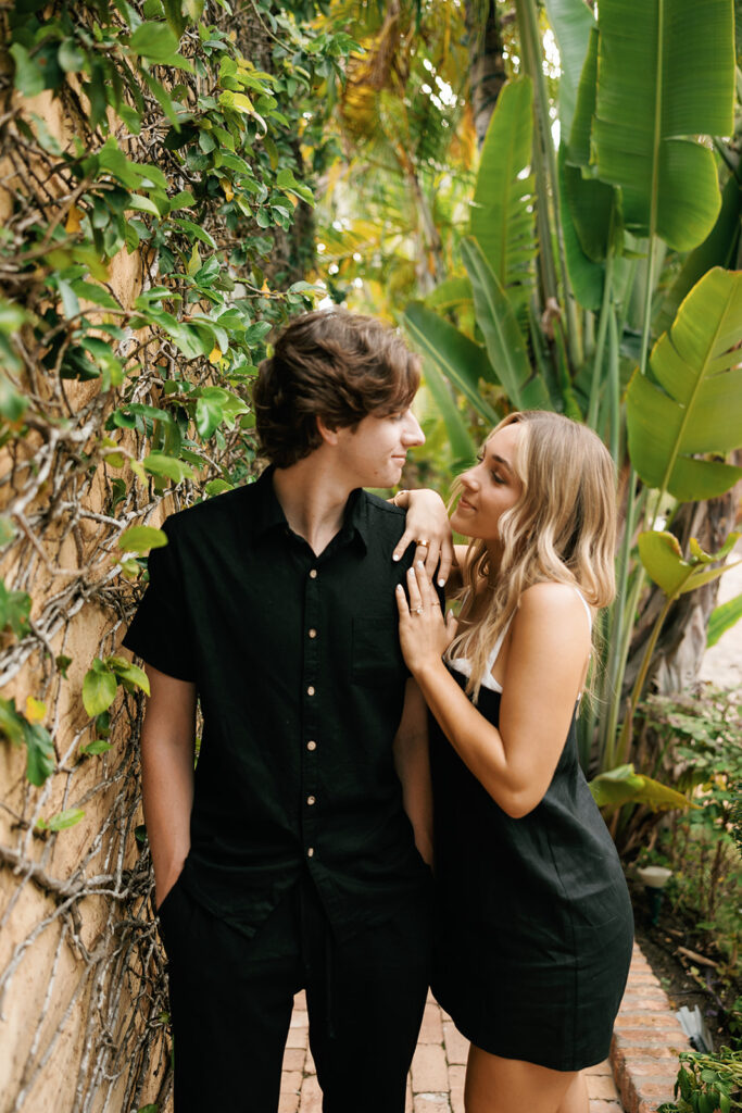 couple smiling at each other for downtown naples beach engagement session