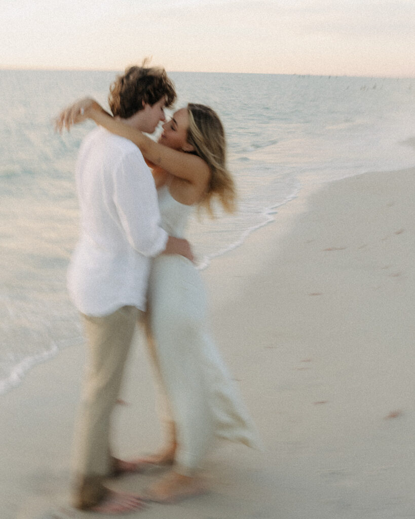 naples florida beach sunset engagement with couple kissing