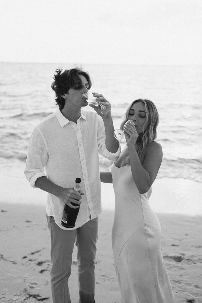 naples florida beach sunset engagement photos of couple drinking