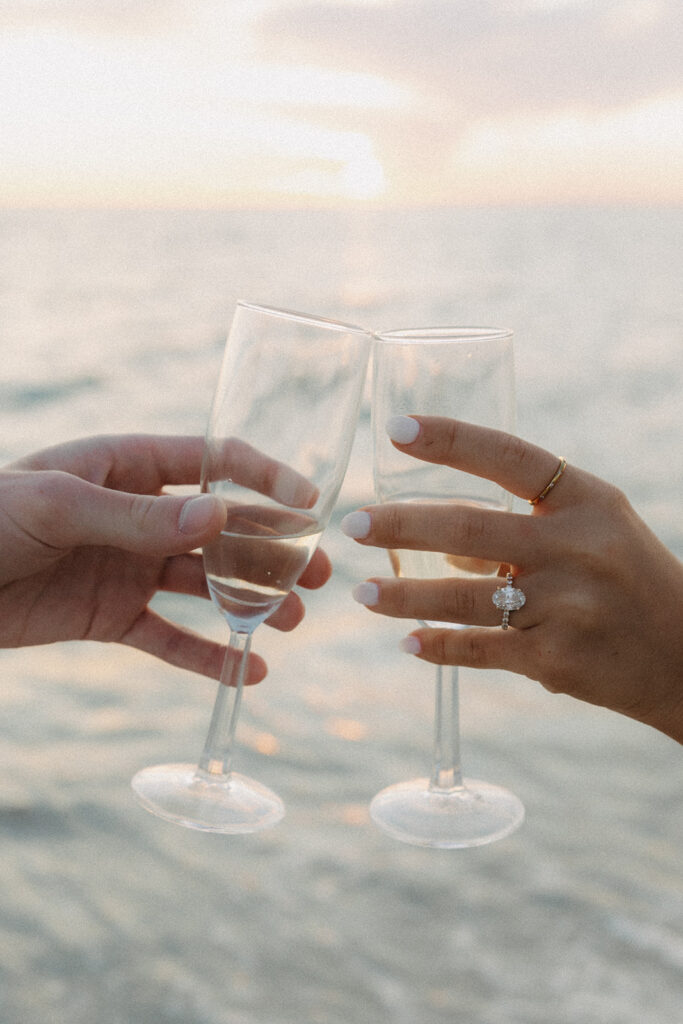 hands with champagne glasses for naples florida beach sunset photo