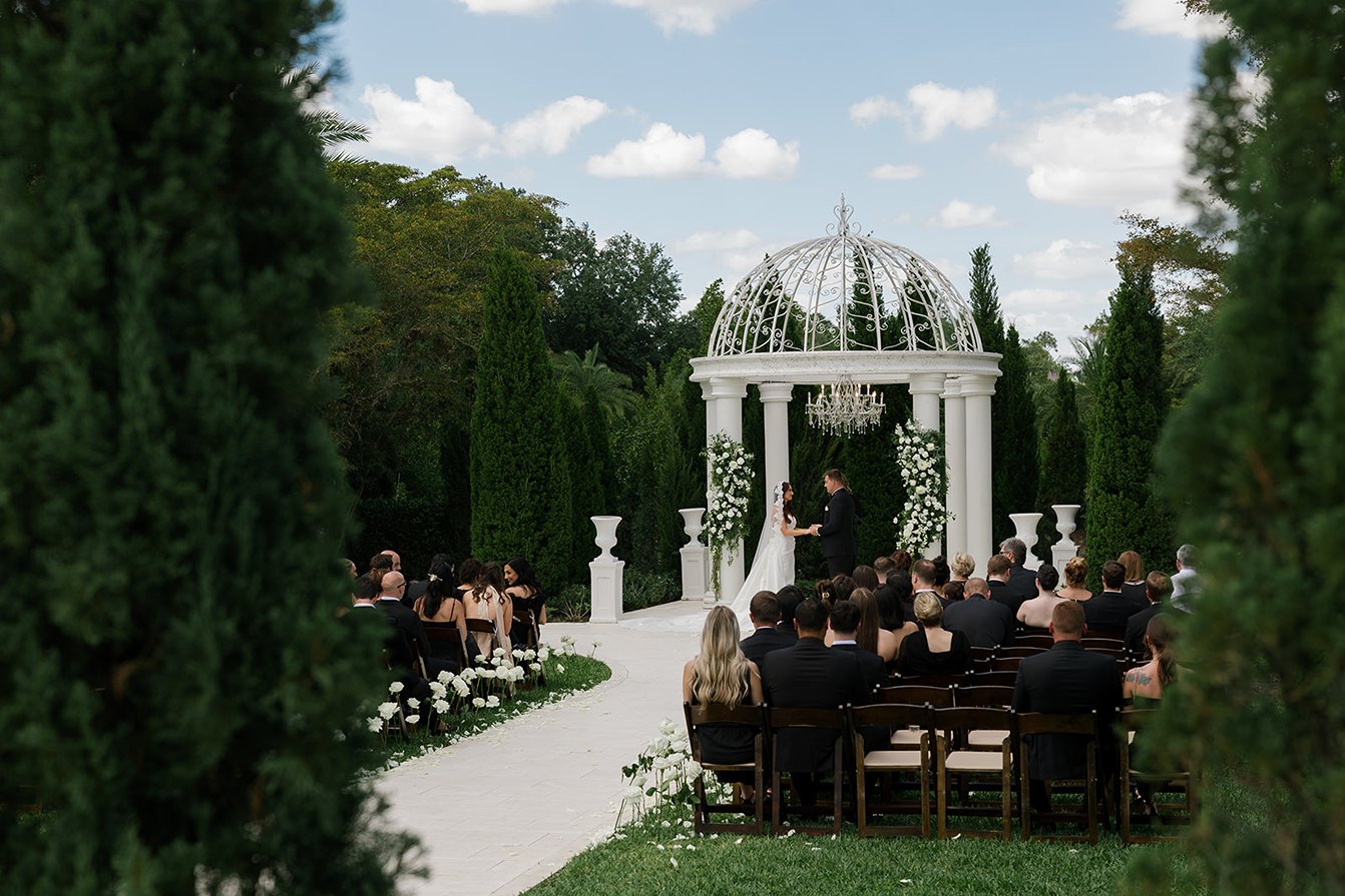 the bride and groom at the altar at their la casa toscana wedding