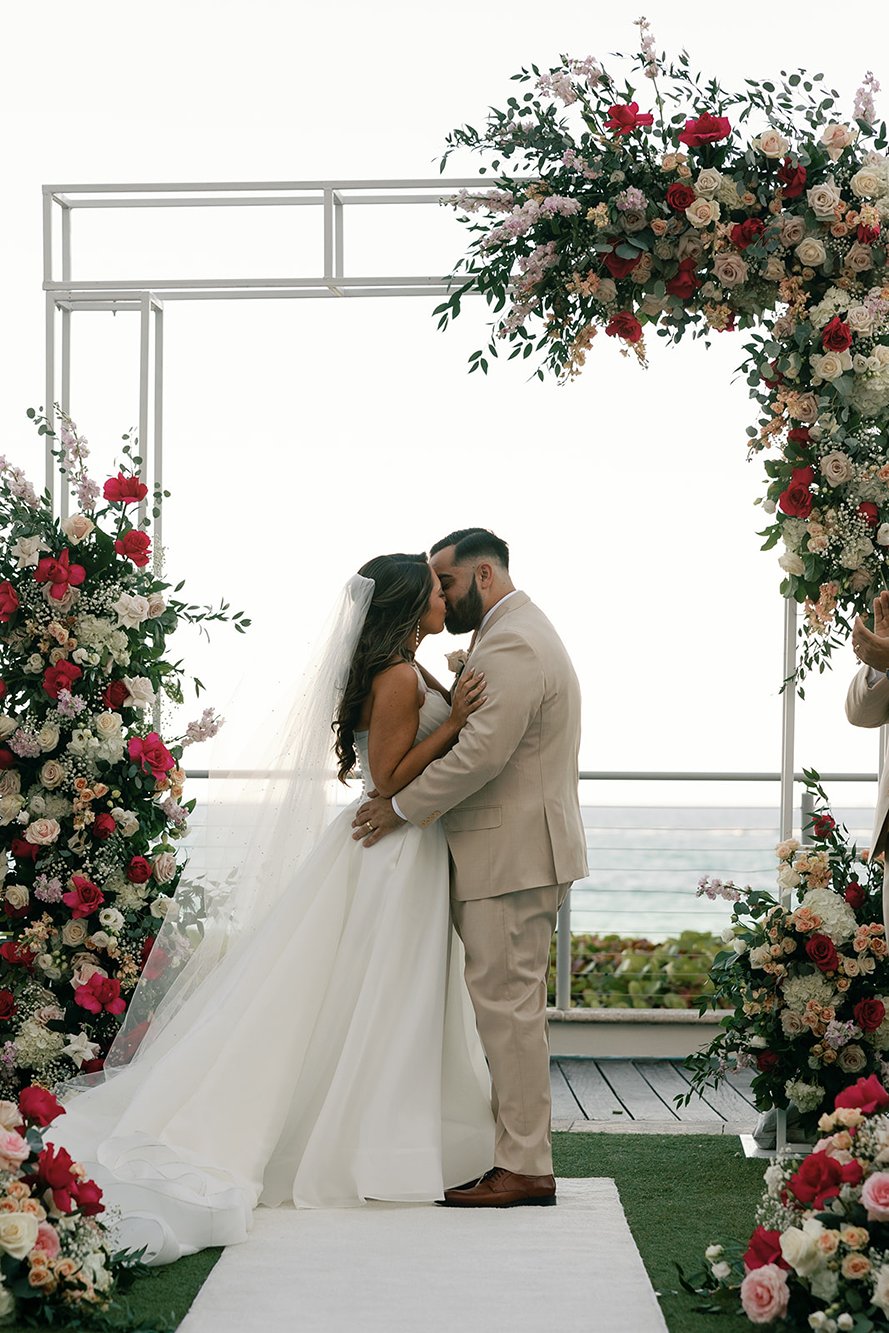 the bride and groom stealing a kiss at their marriott harbor beach wedding