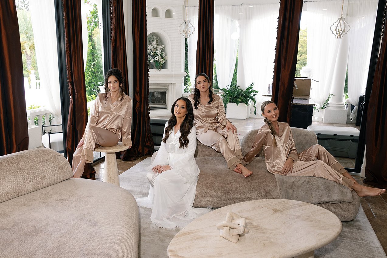 the bridal party posing for a picture at la casa toscana