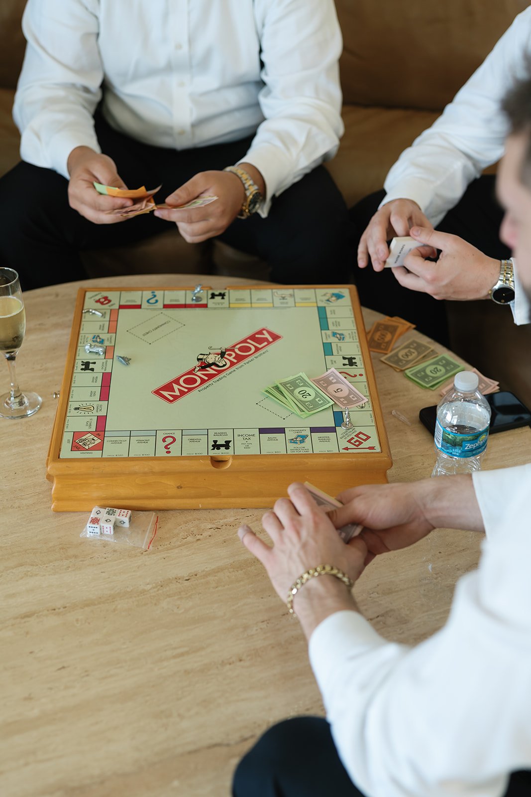the guys playing monopoly at a la casa toscana wedding