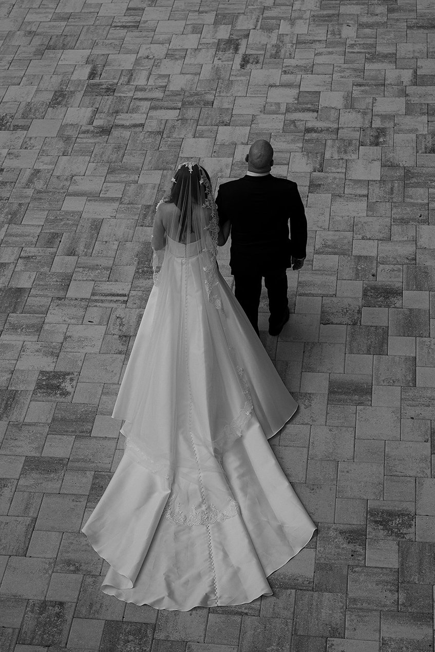 the bride and her faither making their entrance for the wedding at la casa toscana