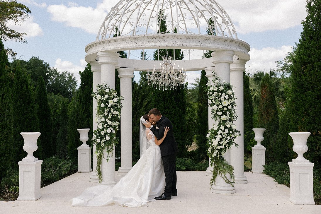 a couple sharing a kiss at their la casa toscana wedding in SWFL