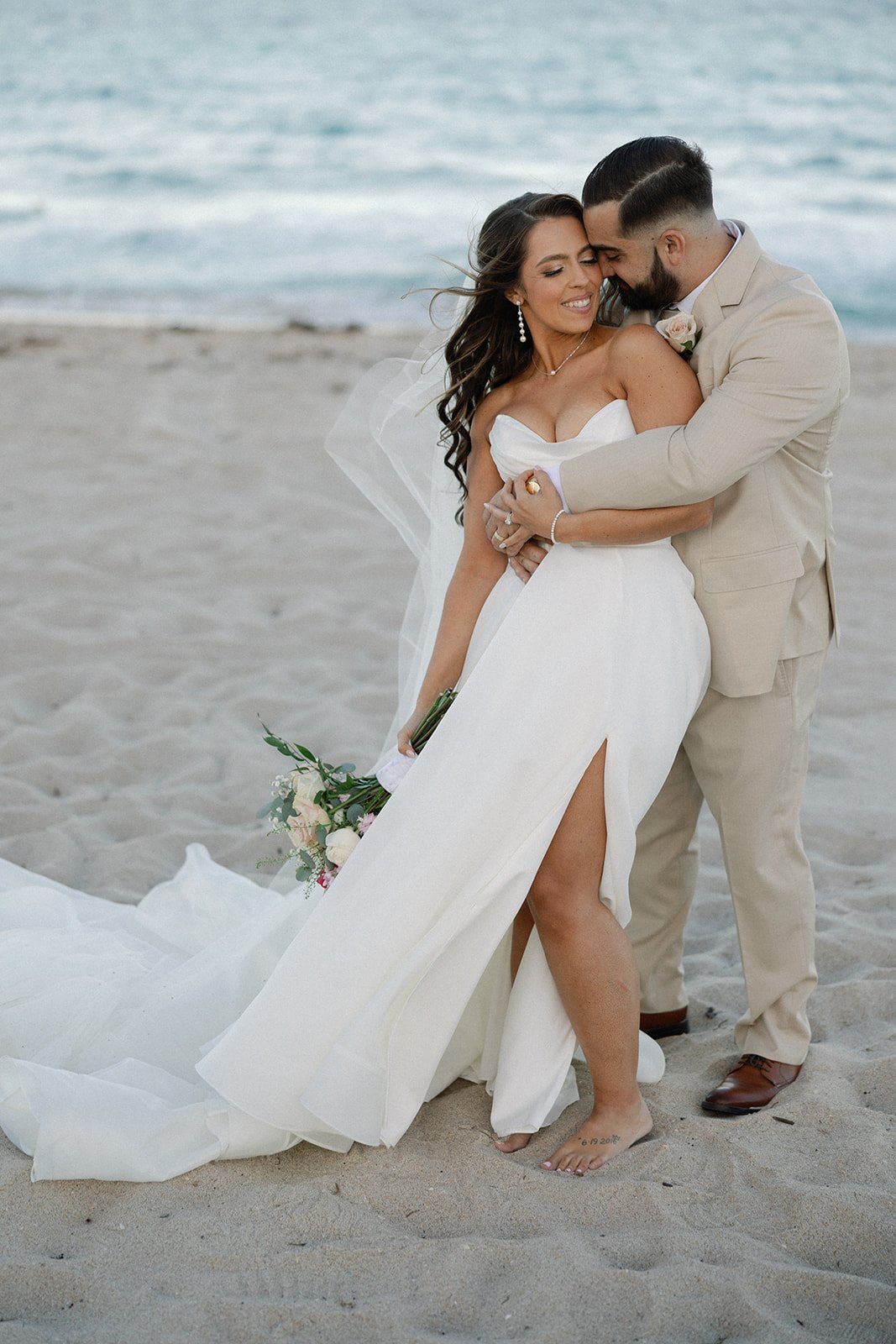 a picture of the couple posing on the beack by a naples florida photographer and videographer