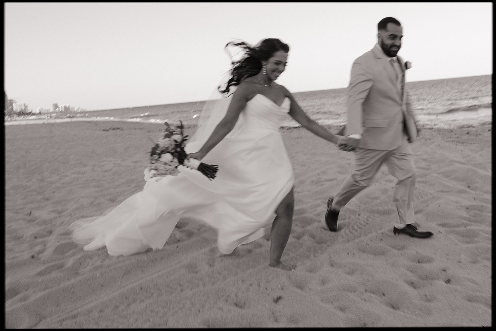 a couple at the marriott harbor beach wedding running on the beach