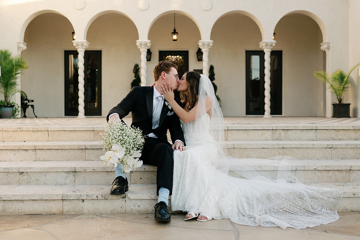 the bride and groom sharing a kiss at their wedding at the Alderman House captured by a miami photographer