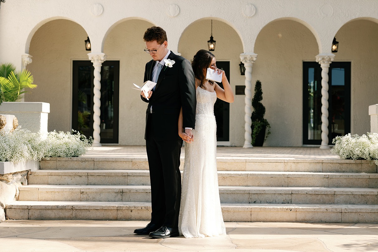the bride and groom exchanging vows at the wedding at the Alderman House