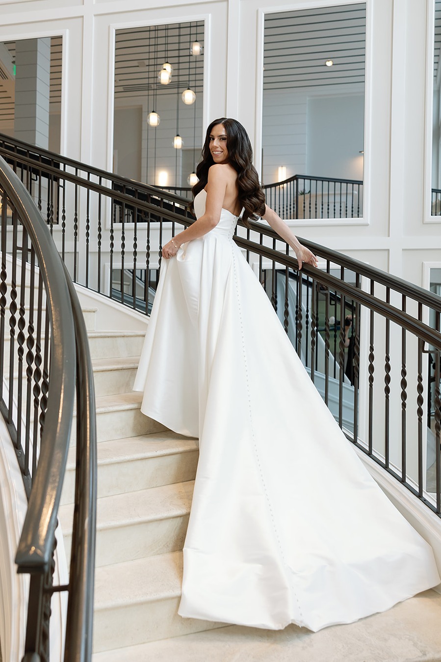 the bride walking p the stairs at the hideaway beach club in naples florida