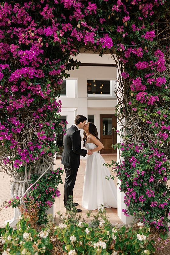 the bride and groom stealing a kiss at the hideaway beach club in Naples Florida