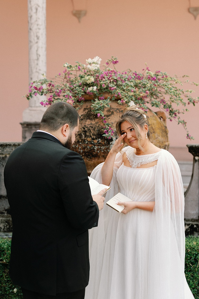 the bride tearing up during their vows at the ringling, one of the best wedding venues in south florida