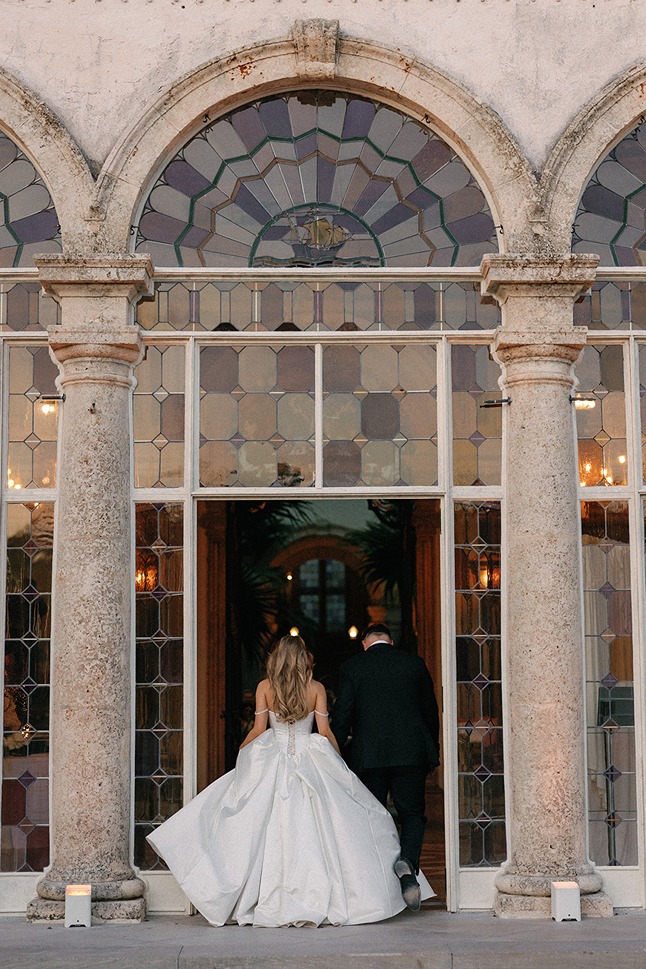 the bride walking into the ceremony at the ringling one of the best wedding venues in south florida