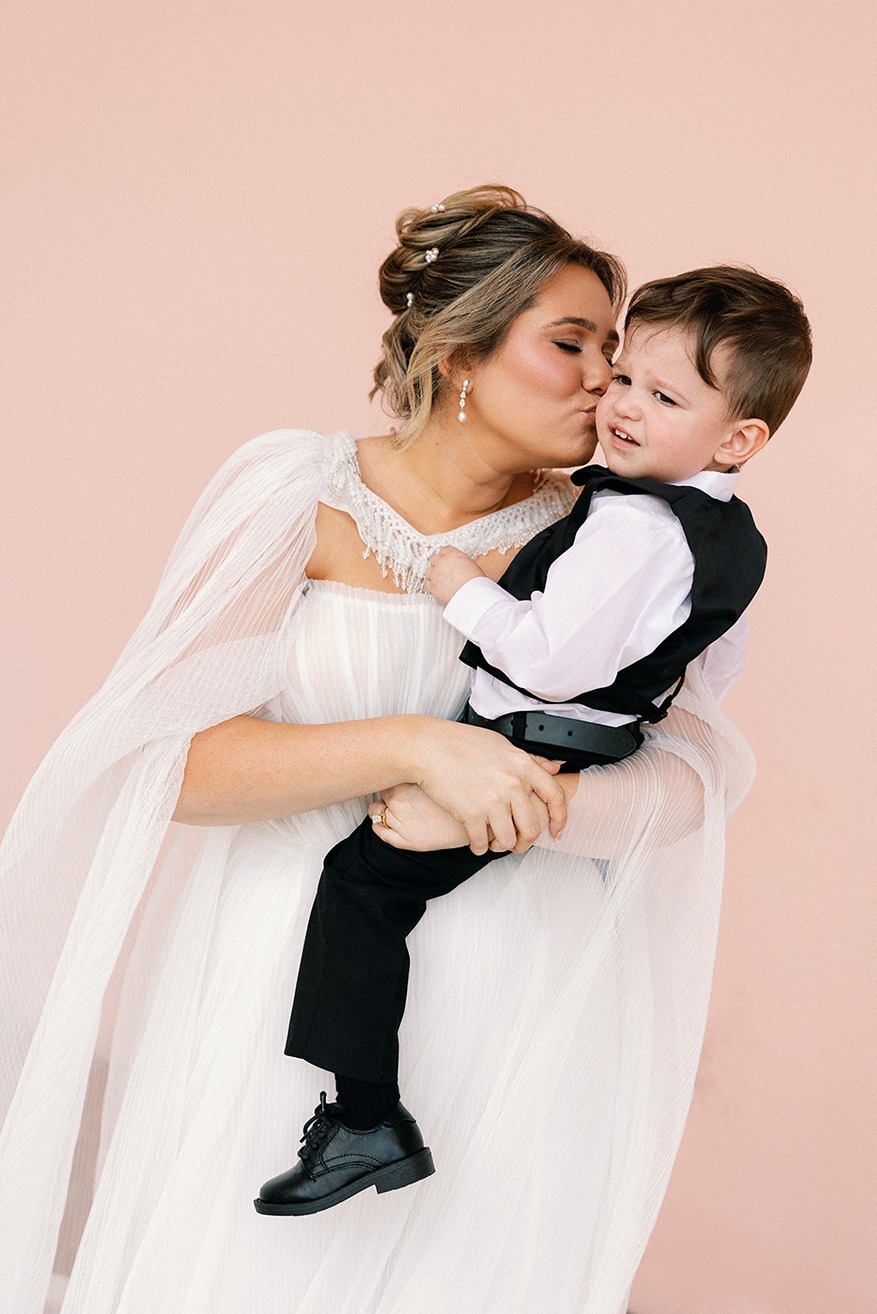 the bride holding the ring bearer at the ringling museum wedding venue