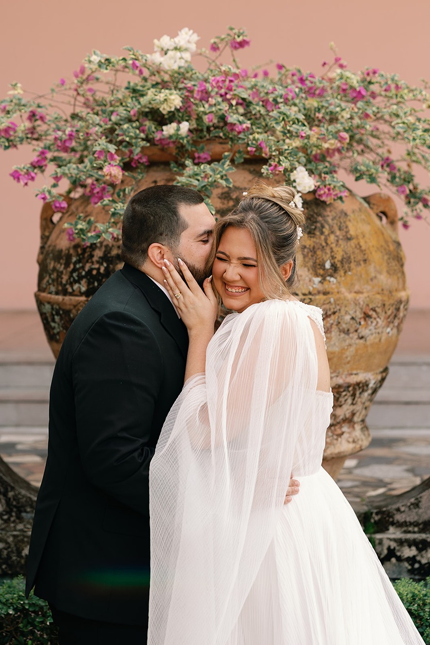 a groom kissing his bride at the ringling museum wedding venue in sarasota florida