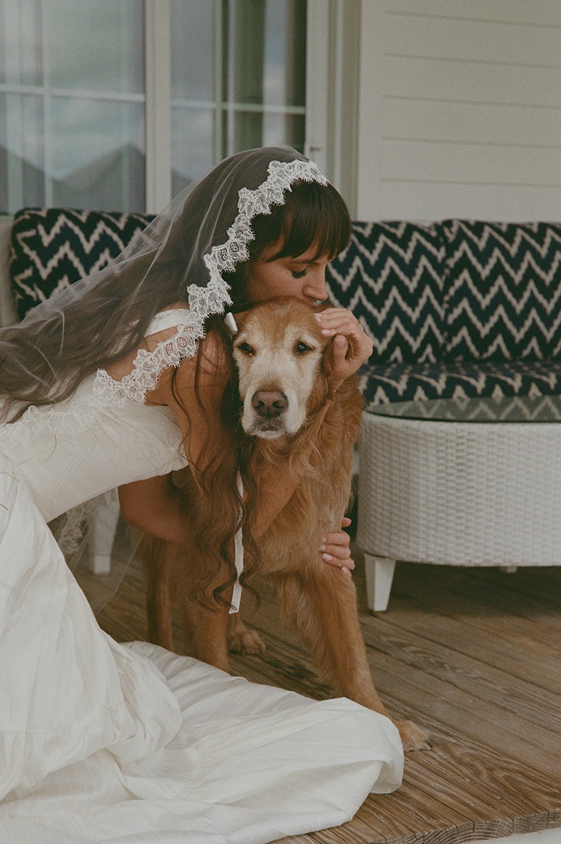 a bride and her pup at the isla bella beach resort restaurant