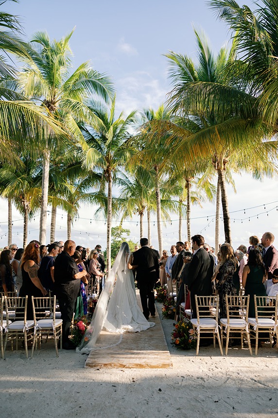 the bride and groom walking down the aisle at isla bella beach resort wedding