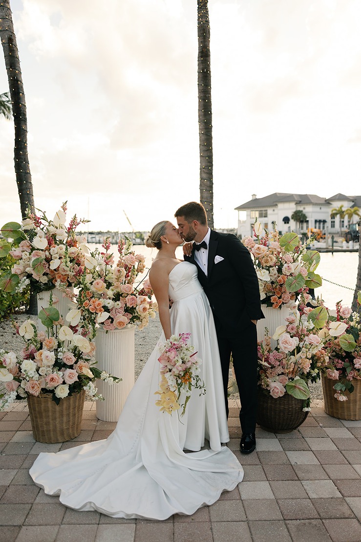 the bride and groom kissing at the naples bay resort