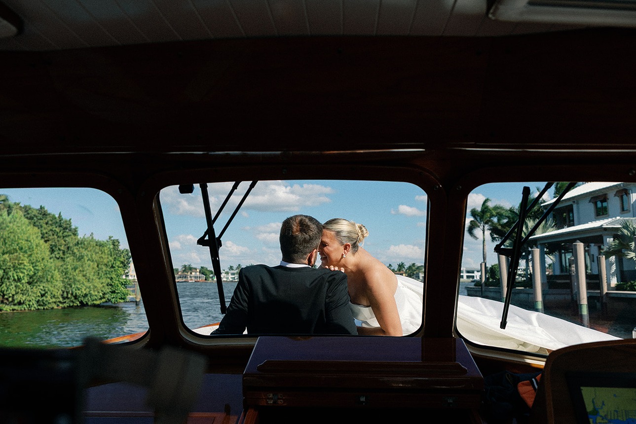 the bride and groom on the boat at their naples wedding