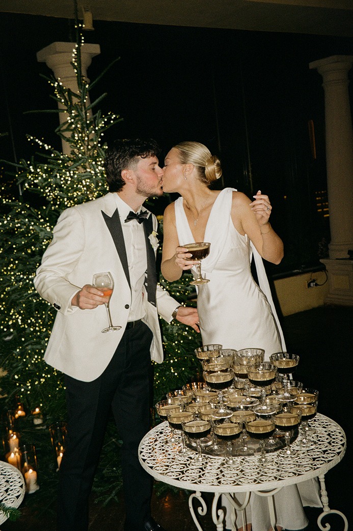 the bride and groom with their espresso tower at antica fattoria paterno