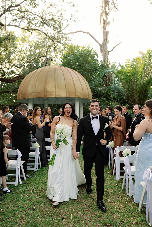 the bride and groom walking out of their shangri la bonita springs wedding