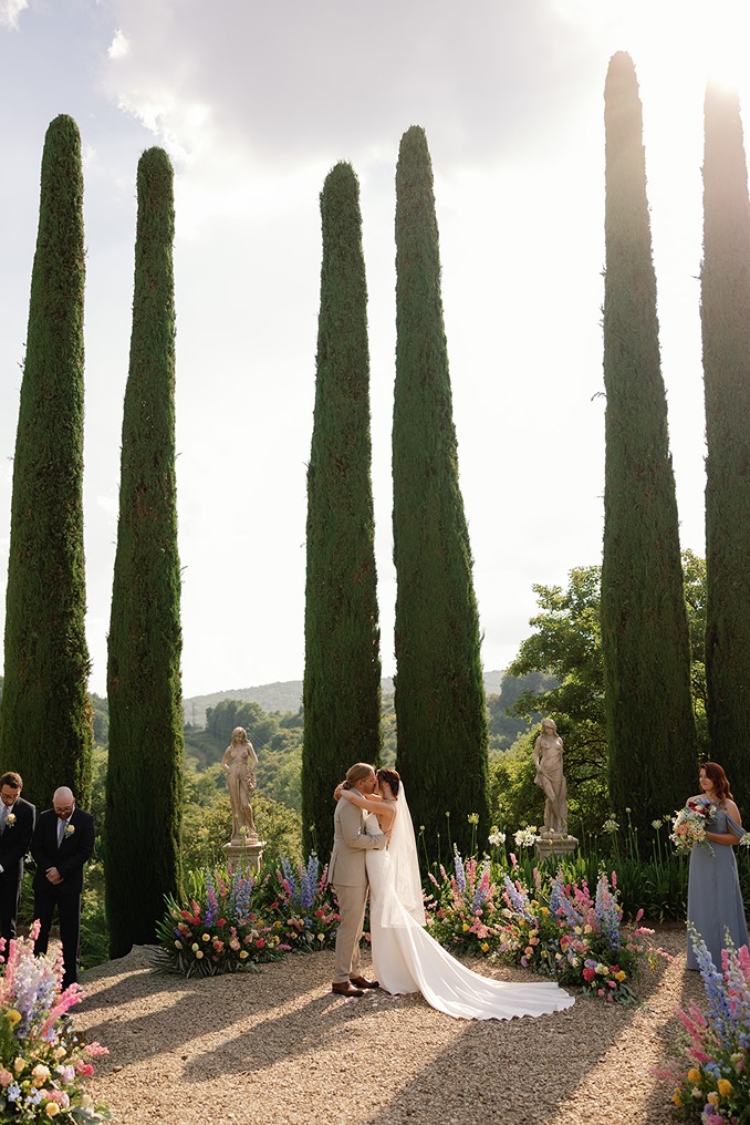 a photo of the bride and groom kissing captured by a wedding photographer in italy