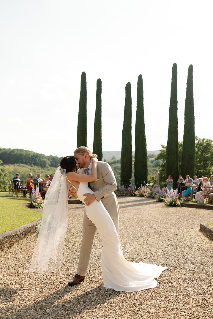 a photo of the bride and groom kissing captured by a wedding photographer in italy