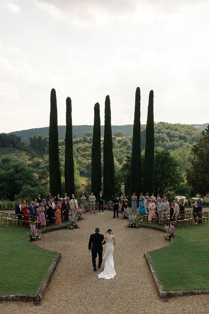 the bride walking down the aisle captured by a wedding photographer in italy