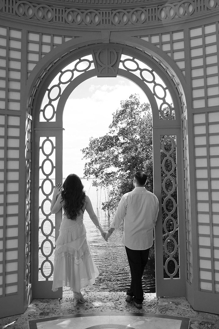 vizcaya museum and gardens engagement photos of the future bride and groom overlooking the water