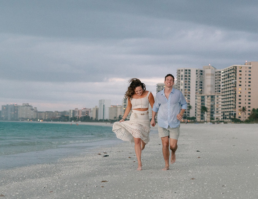 marco island photos of the couple running on the beach