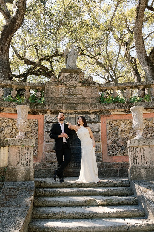 vizcaya museum and gardens engagement photos of the future bride resting on the groom