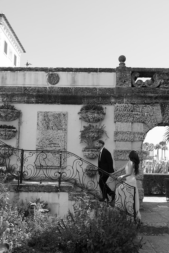 vizcaya museum and gardens engagement photos of the couple walking up the stairs