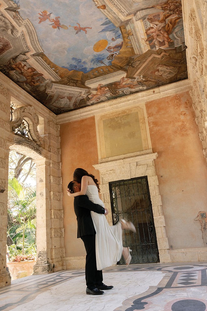 vizcaya museum and gardens engagement photos of the future bride and groom under the architectural details