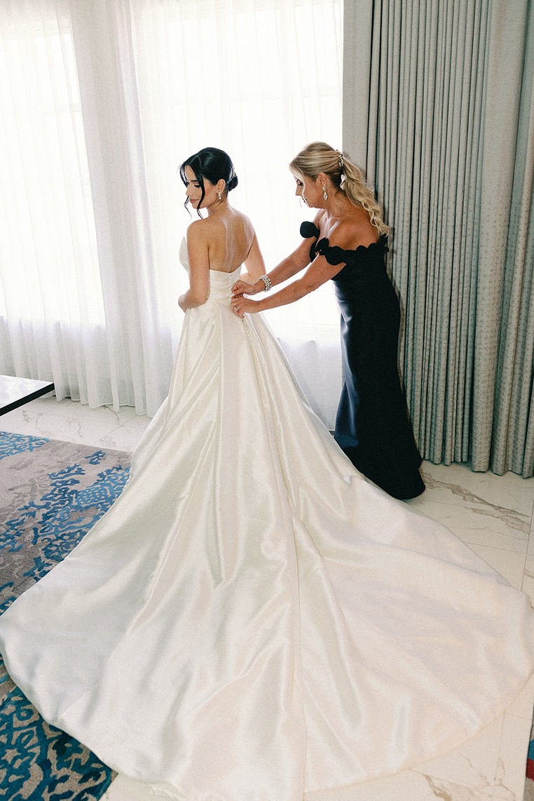 the bride getting dressed for her miami wedding photos