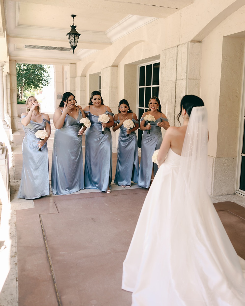 the bridesmaids swooning over the bride in the miami wedding photos