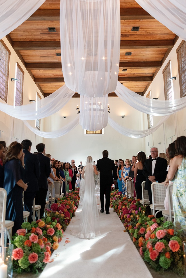 the bride and groom walking down the aisle at their rosemary beach wedding ceremony